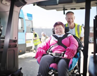 A fully equipped wheelchair-accessible NEMT van with a ramp extended.