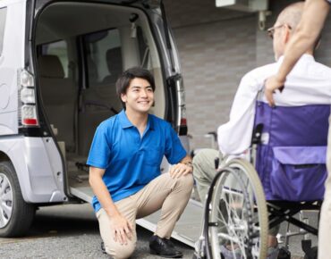 A senior passenger seated comfortably inside an NEMT van.